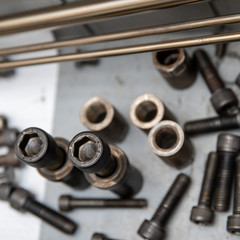 bolts and nuts in a box in a factory repair machine
