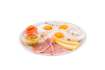 Three fried eggs garnished with cheese, ham and tomatoes. Photo taken on a white background. Dish of Montenegrin cuisine. Suitable for the restaurant menu.