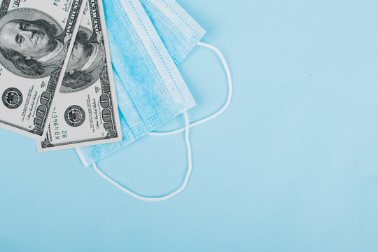 Sale of medical masks. Medical mask with money on blue background. Coronavirus concept. 2019 nCoV.