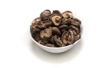 Dried Shitake Mushroom   into a wooden bowl