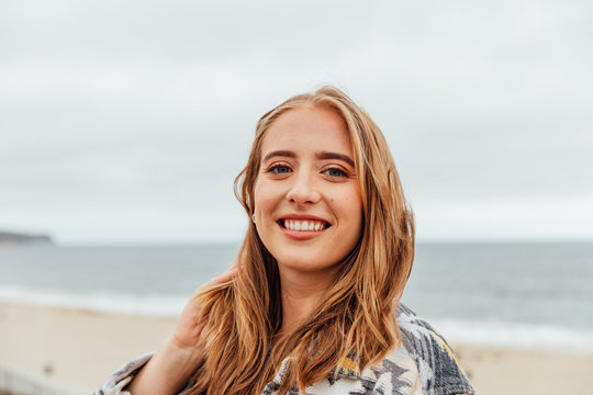 Millenial Woman Smiling At The Beach