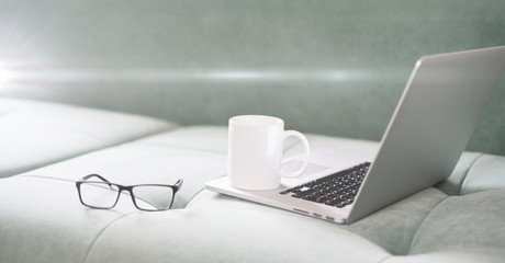 a laptop at home, a simple working place for a freelancer, work online, telework during covid coronavirus pandemy