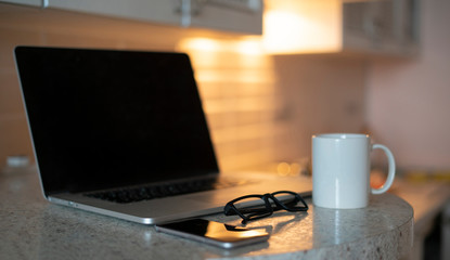 a laptop at home, a simple working place for a freelancer, work online, telework during covid coronavirus pandemy