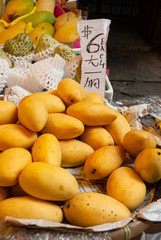 Naklejka na ściany i meble Group of mangoes for sale in Hong Kong dry market, organic imported sweet-tasting products, source of fiber and vitamins.