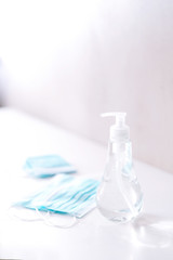 Coronavirus prevention medical  sterile masks and hand sanitizer gel for hand hygiene coronavirus protection. The concept of preventing the spread of the epidemic and treating  pandemic in quarantine 