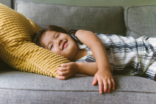 Happy Kid Lying On Couch At Home