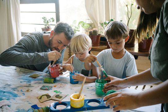 Dad painting with his sons