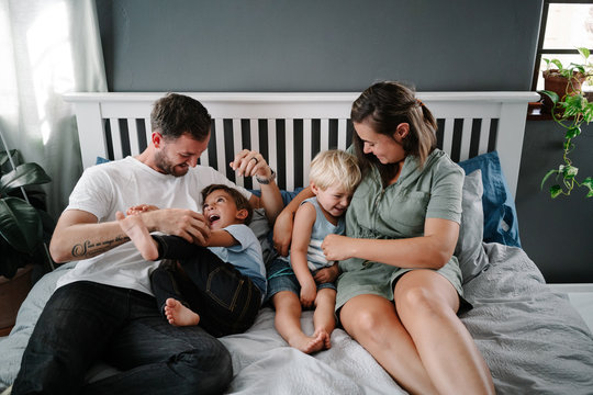 Family playing on the bed