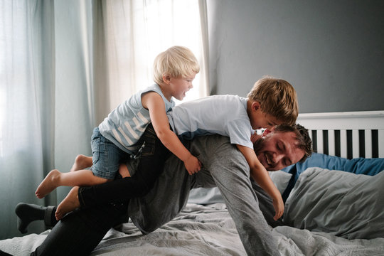 Dad and sons playing
