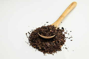 Toasted Erva-Mate into a measuring spoon.
