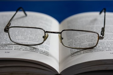 open book and  reading glasses