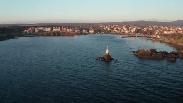 A drone flight at sunrise around the lighthouse in the port of Ahtopol, Black sea coast, Bulgaria