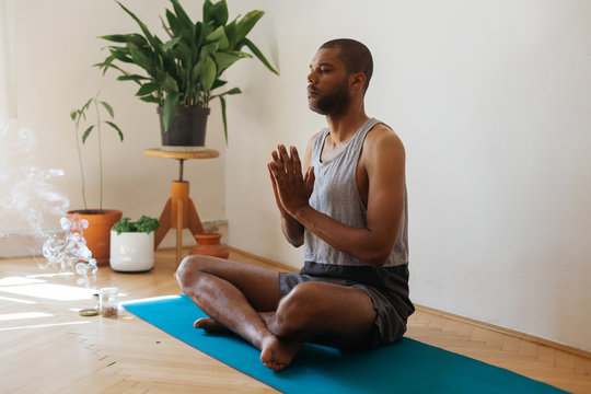 Adult Man Meditating At Home