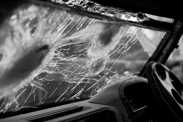Bullet hole on a car windshield. Car window after a raid has a bullet hole. Broken glass. Bullet holes in a front windshield. Broken Windshield.