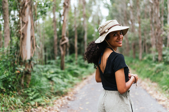 Cheerful And Beautiful Woman Looking Back To The Camara, Wearing Safari Hat.