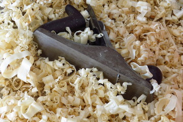 An old wood plane amongst the wood shavings it created.