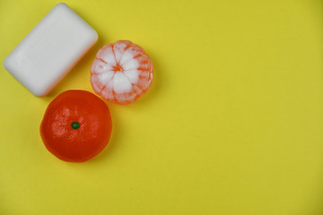 Mandarin-shaped toilet handmade soap on bright yellow background
