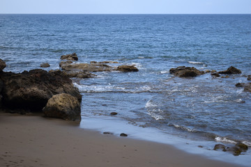 Waves Lapping Sandy Beach with Rocks  in Gran Canaria 