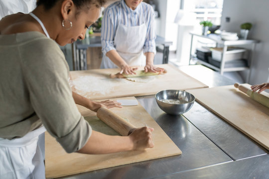 Preparing dough in a kitchen class - Powered by Adobe