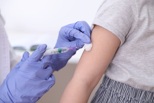 Little girl receiving chickenpox vaccination in clinic, closeup. Varicella virus prevention