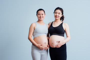 Portrait of two pregnant woman in yoga studio