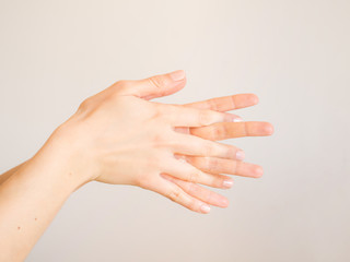 Female hands cleaning washing with sanitizer gel over bright gray background - 333018815