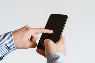 close up view of a man using mobile phone indoors. Technology concept