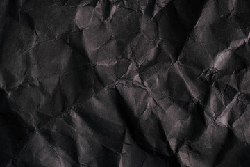Black texture background. Crumpled paper.