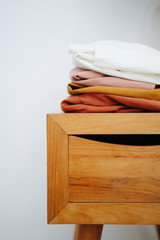 Laundry on a wooden bedside table. Close up