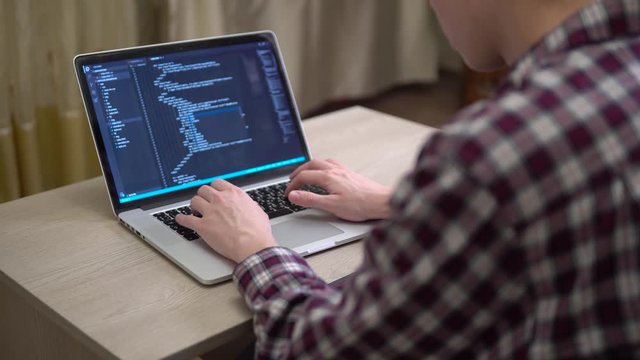 Man coding html over the shoulder developer working at home freelance script