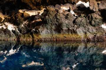 View of underground caves with reflection in water