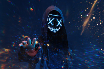 Dangerous hooded hacker in mask. Internet, cyber crime, cyber attack, system breaking and malware...