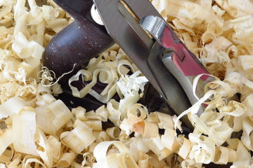 An old wood plane amongst the wood shavings it created.