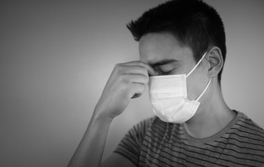 Stressed female wearing protective face mask. Coronavirus, fear, health concept.