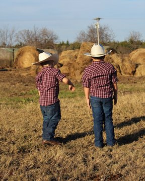 Two Little Cowboys In  A Pasture in South Central Oklahoma to Checking on the Hay