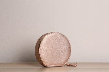 Stylish leather woman's bag on wooden table