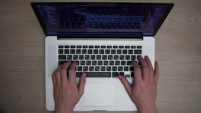 Man coding html developer programming on laptop hands top shot develop website