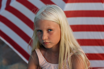 Little girl on the red striped umbrella background