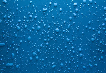 Naklejka na ściany i meble Water drops on blue surface
