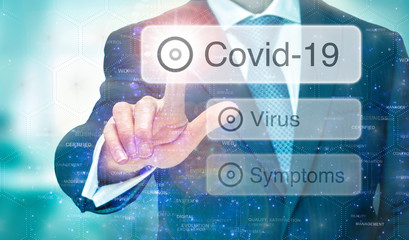 A man selecting message for   Covid-19 global virus pandemic instructions on a blue digital screen.