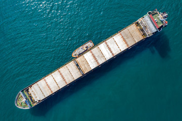 Big empty ship at sea. Aerial top view of cargo ship vessel import-export sailing.