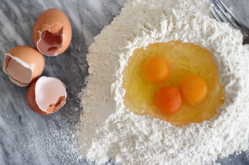 Eggs in a flour well for pasta making