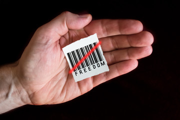 Paper Note with a Barcode that is Beeing Scanned and the Word Freedom
