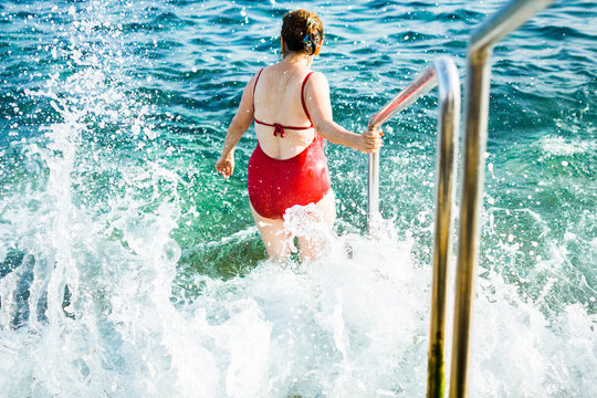 Older Woman Going Into Ocean