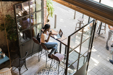 Young woman working at cafe