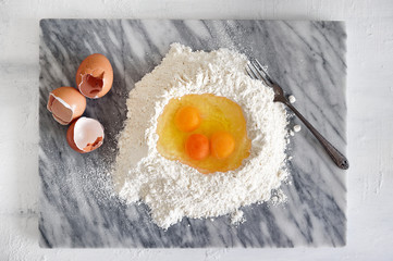 Eggs in a flour well for pasta making