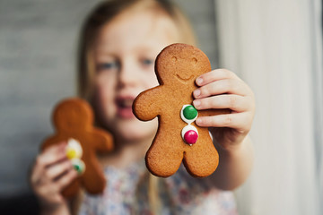 Child eating gingerbread biscuit