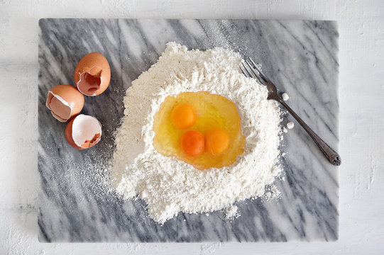 Eggs in a flour well for pasta making