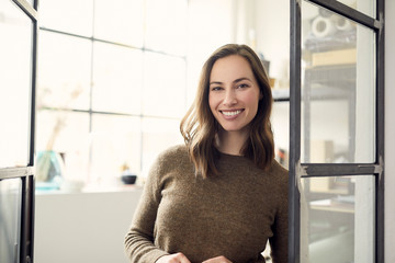 Portrait of creative attractive young woman stading in front of her hobby room