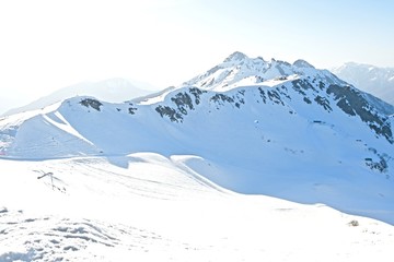 Fototapeta na wymiar paragliding over a snowy mountain landscape at a ski resort